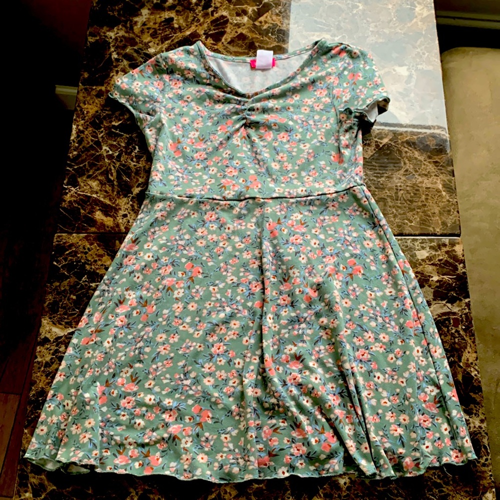 A blue dress with a floral pattern